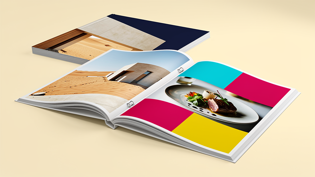 An open premium magazine showing the binding, page layers, photography, and coated paper finish